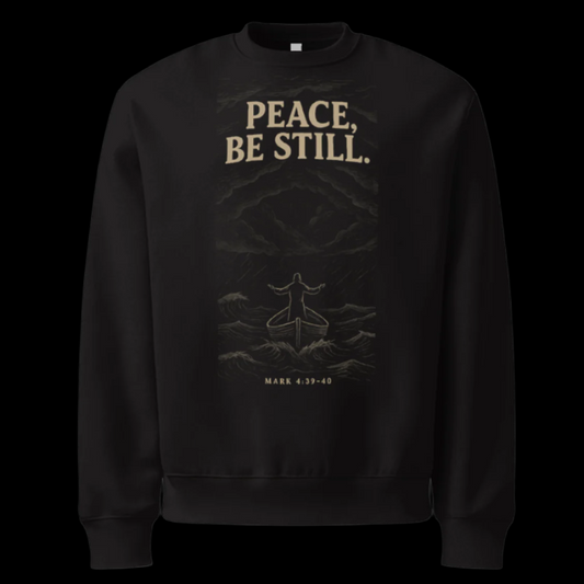 Black sweatshirt with 'PEACE. BE STILL.' text and design on a white background